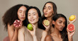 Women, portrait and beauty, diversity and fruit with dermatology and friends on studio background. Unique skin, natural cosmetics and inclusion, eco friendly skincare, smile and citrus for vitamin c