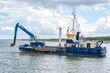 ship with excavator for dredging the entrance to the port