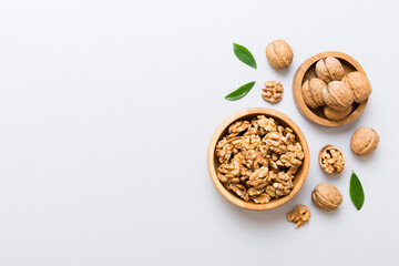 Wall Mural - Walnut kernel halves, in a wooden bowl. Close-up, from above on colored background. Healthy eating Walnut concept. Super foods with copy space