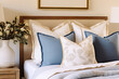 © Amornrat - Elegance in Simplicity Blue Pillows Adorn a Modern Bedroom in French Country Style. created with Generative AI