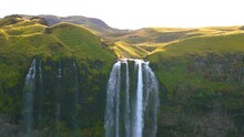 Breathtaking Natural Waterfall Descending From Towering Volcanic Rock Formations