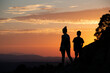 © SaucE ReQuEs - Silhouettes of a single-parent family on a sunset in the mountains