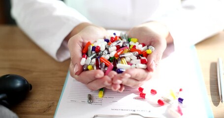 Wall Mural - Doctor holding lot of multicolored pills in his hands closeup 4k movie slow motion. Treatment with dietary supplements polypharmacy concept