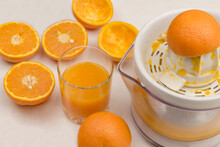 Peel Of Fresh Orange On Juicer. Glass Of Juice And Oranges