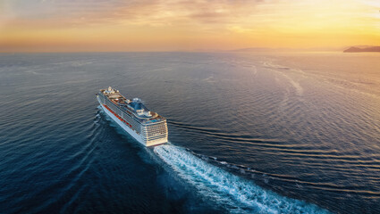 Wall Mural - aerial view of a cruise ship traveling over the ocean during a golden summer sunset with copy space