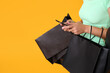 © Pixel-Shot - Beautiful young Asian woman with shopping bags and mobile phone on yellow background, closeup. Black Friday sale