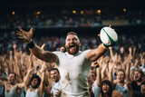 Fototapeta Sport - Rugby player in a white uniform, rejoices at a thrown ball in a stadium filled with spectators