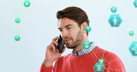 Poster - Animation of connected icons globe over caucasian man standing and talking on smartphone