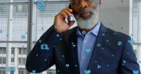 Poster - Animation of connected icons over african american businessman walking while talking on cellphone