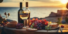 Beautiful Summer Romantic Picnic At Sunset On Sand Beach. Bottles Of Red And White Wine, Baguete, Cheese, Grapes And Fresh Fruits On Napkin On Wooden Board On Blurred Seascape.