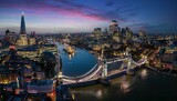 Fototapeta Fototapeta Londyn - Panoramic view of the illuminated London skyline with Tower Bridge and river Thames until the City during night time