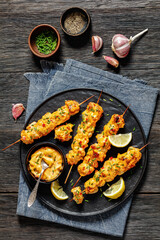 Wall Mural - Bang Bang Chicken Skewers on plate, top view