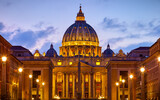 Fototapeta  - Vatican City (Holy See. Rome, Italy. Dome of St. Peters Basil cathedral at Saint Peter's Square. Evening sunset, golden hour with evening sky and street lamps.