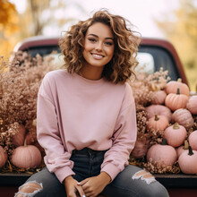 Beautiful Woman Wearing A Solid Pink Crewneck Sweatshirt Mockup Sitting In The Back Of An Old Vintage Pickup Truck Surrounded By Fall Pumpkins