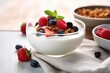 a bowl of greek yogurt with granola and berries
