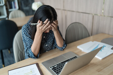 Burnout concept. Asian Business woman touching forehead having h