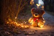 bear toy on a park path illuminated by string lights