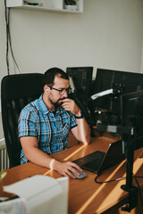 Wall Mural - Portrait professional man programmer working concentrated on computer in diverse offices. Modern IT technologies, development artificial intelligence, programs, applications and video games concept.