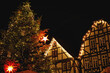 Old market place in Alsfeld, Hesse, Germany with the christmas decoration, old houses with stores, restaurants and visitors of the christmas market. Traditional Christmas market