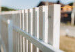 Wooden fence around a beautiful house. fence made of wooden slats.