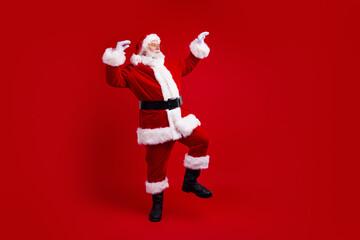 Full length photo of positive jolly pensioner santa claus rejoice special new year offer look empty space isolated on red color background