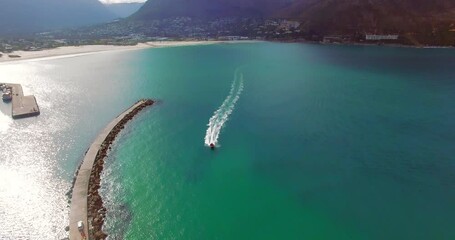 Wall Mural - Drone, speedboat and seaside or ocean on sea for travel, vacation or holiday with mountain background. Aerial view, beach and lake in Africa with boat or transportation for adventure in Cape Town