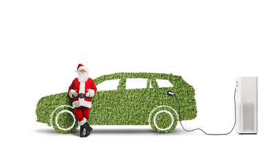 Sticker - Santa claus leaning on a green car at a charging station