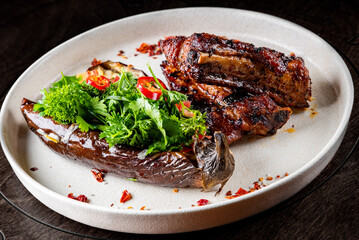 Wall Mural - grilled pork ribs with baked eggplant on plate