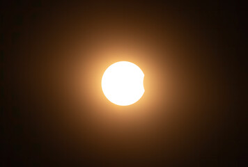 Wall Mural - partial annular solar eclipse through the clouds - october 14, 2023, kanata, ontario, canada