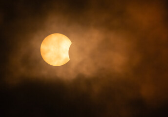 Wall Mural - partial annular solar eclipse through the clouds - october 14, 2023, kanata, ontario, canada