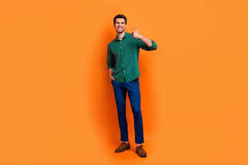 Sticker - Full length photo of excited confident man dressed green shirt showing thumb up isolated orange color background