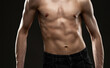 © Dimid - Silhouette of a slender muscular man doing sports in the gym. Sports and healthy lifestyle.