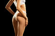 © master1305 - Cropped image of fit, smooth female body, buttocks in white underwear against black studio background. Anti cellulite care. Concept of natural beauty, body and skin care, health, sport, wellness.