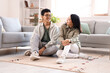 © Pixel-Shot - Young Asian friends sitting at home