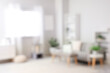 © Pixel-Shot - Blurred view of light living room with sofa and soft bench