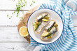 Sardines sandwiches on a white wooden background. Mediterranean food. Top view