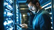 © visoot - Modern IT developer using digital tablet standing by server cabinet while working with supercomputer.