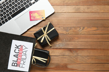 Sticker - Black Friday sale greeting card with laptop, gift boxes, shopping bag and credit card on wooden table