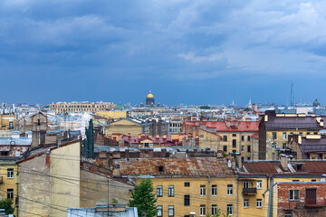 Wall Mural - top view of the city roofs in the historical center of Saint Petersburg before the onset of a thunderstorm