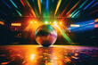 A disco ball lies on the floor of an empty disco with 80s style disco lights. Concept motif for 80s, disco and party.
