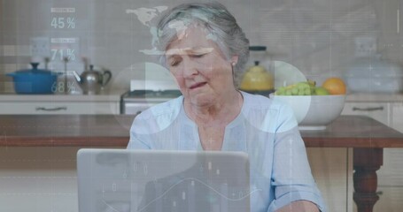 Poster - Animation of financial data processing over senior caucasian woman using laptop