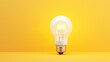 White light bulb on isolated yellow background with copy space