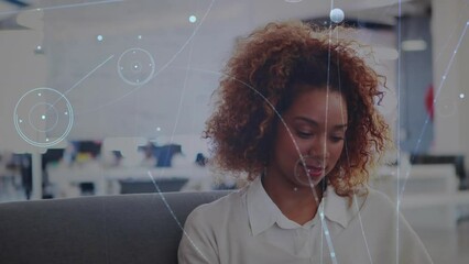 Poster - Animation of network of connections against african american woman using smartphone at office