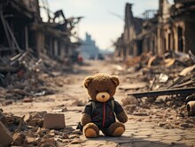 Brown Teddy Bear On Road In City War Situation Building Destroy By Missile In Bird Eyes View