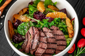 Wall Mural - Salad with roast beef and caramelized beets with orange fillet, potatoes, parmesan, salad mix and olive oil