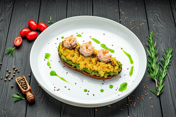 Wall Mural - Scrambled on toast with guacamole, shrimp and olives