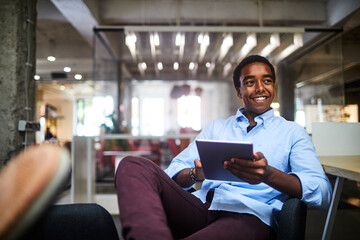 Successful young businessman using a tablet in a modern office