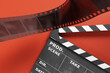 Minimal background with movie clapperboard and film, 3d rendering