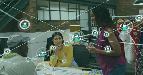 Poster - Animation of icons connected with lines over diverse designers sharing ideas in office