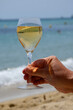 Summer time in Provence, glass of cold white wine on Pampelonne sandy beach near Saint-Tropez in Var department, France